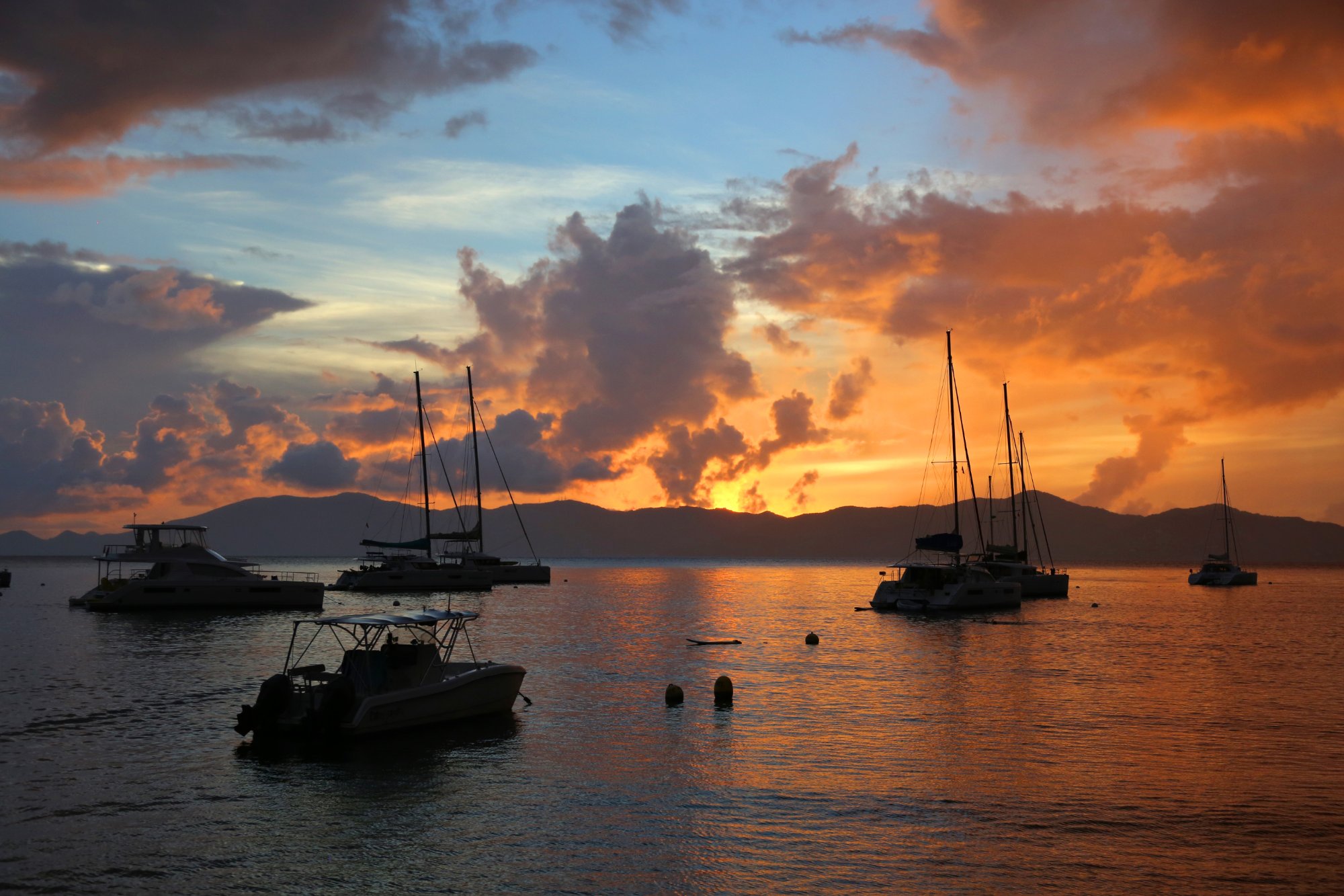 BVI sunset with sailboat silhouettes at anchor