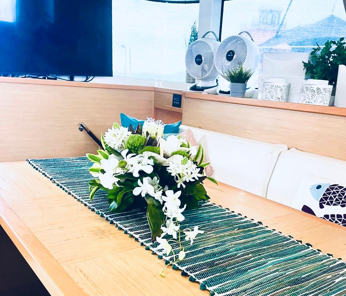 Saloon with lily arrangement and flat-screen TV
